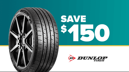 Dunlop tire promotion showing black tire with decorative fireworks on teal background and Save $150 text in white
